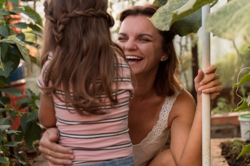 Happy mother with kid in garden