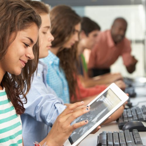 Girl Using Digital Tablet In Computer Class Girl Using Digital Tablet In Computer Class