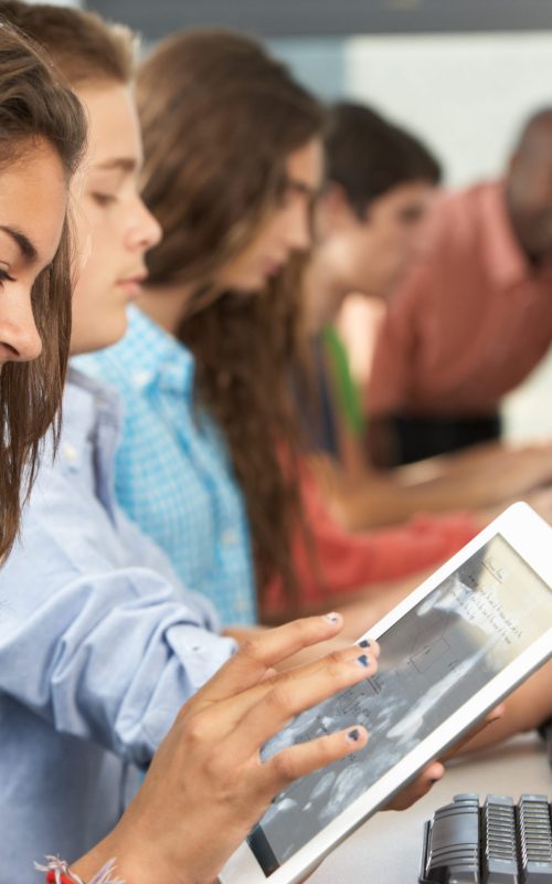 Girl Using Digital Tablet In Computer Class Girl Using Digital Tablet In Computer Class