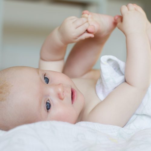 Baby girl lying on back