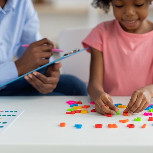 Cute african american child playing with colorful letters