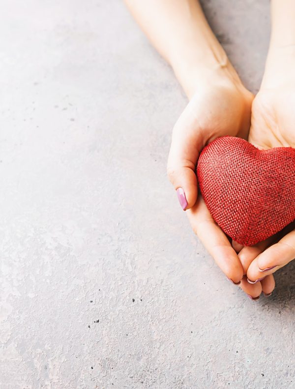 Female hands giving red heart Female hands giving red heart