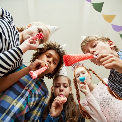 Group of Children Blowing Party Horns
