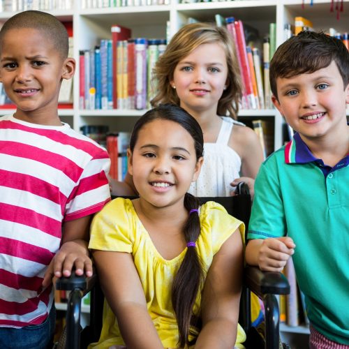 Handicapped girl with friends at library in school Handicapped girl with friends at library in school