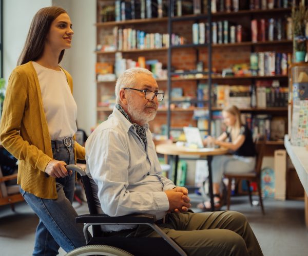 Handicapped older male person and young guardian