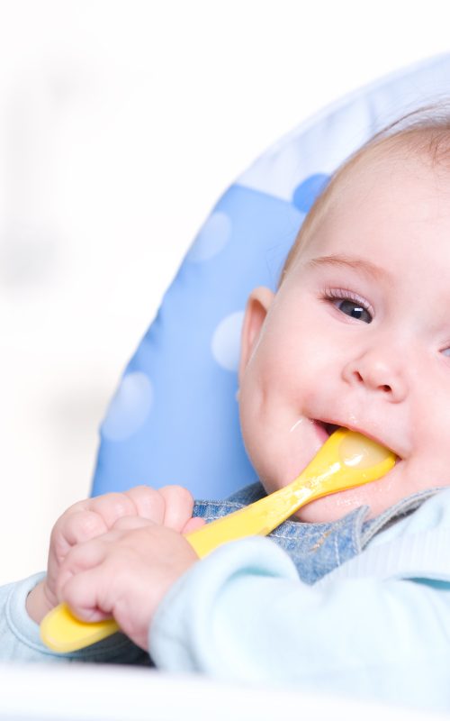 Happy baby with spoon