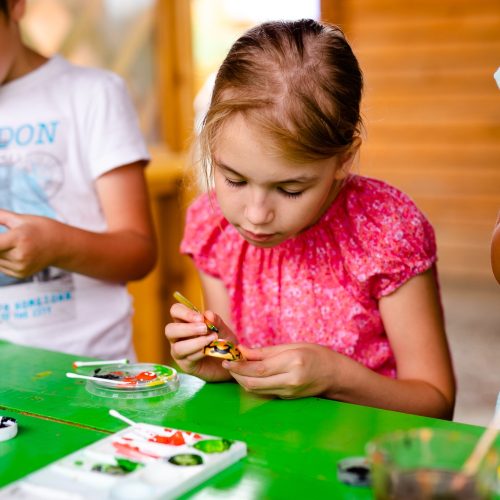 Kids crafting and painting in children’s camping