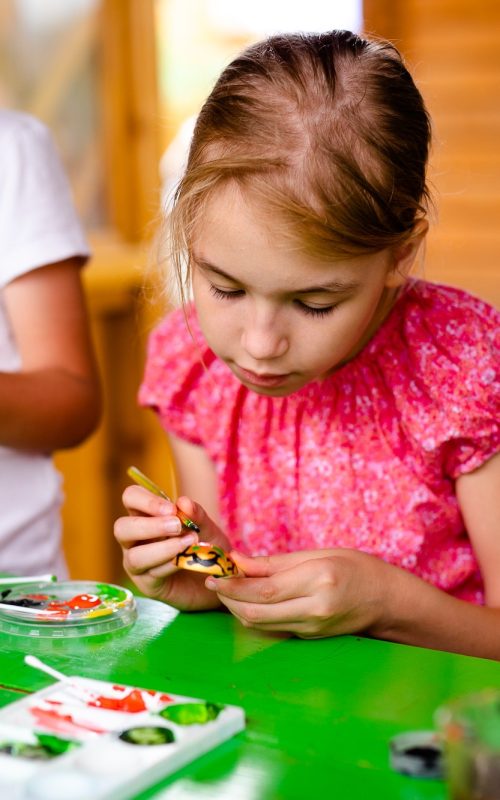 Kids crafting and painting in children’s camping