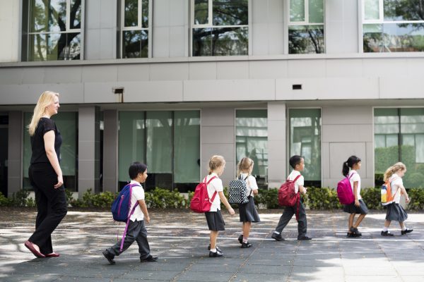 Kindergarten students walking crossing school road Kindergarten students walking crossing school road