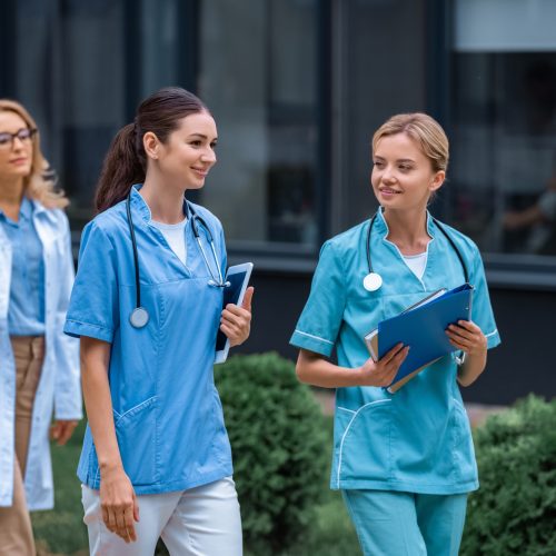 medical students and lecturer walking on street near university medical students and lecturer walking on street near university