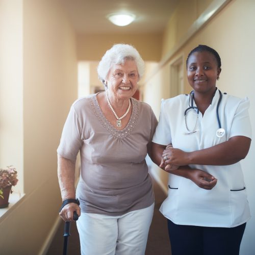 Nurse assisting a senior patient to walk