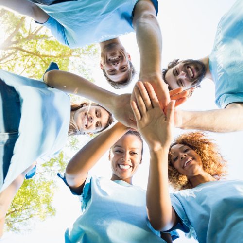 Portrait of volunteer group forming huddles Portrait of volunteer group forming huddles