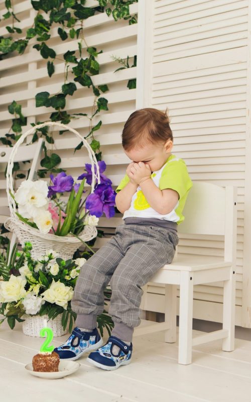 Sad child boy with piece birthday cake