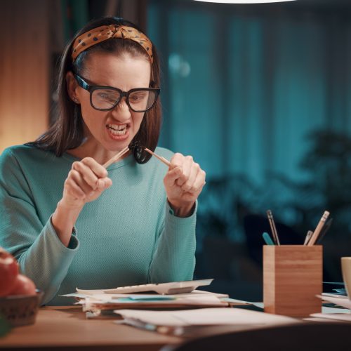 Stressed woman checking paperwork at home Stressed woman checking paperwork at home